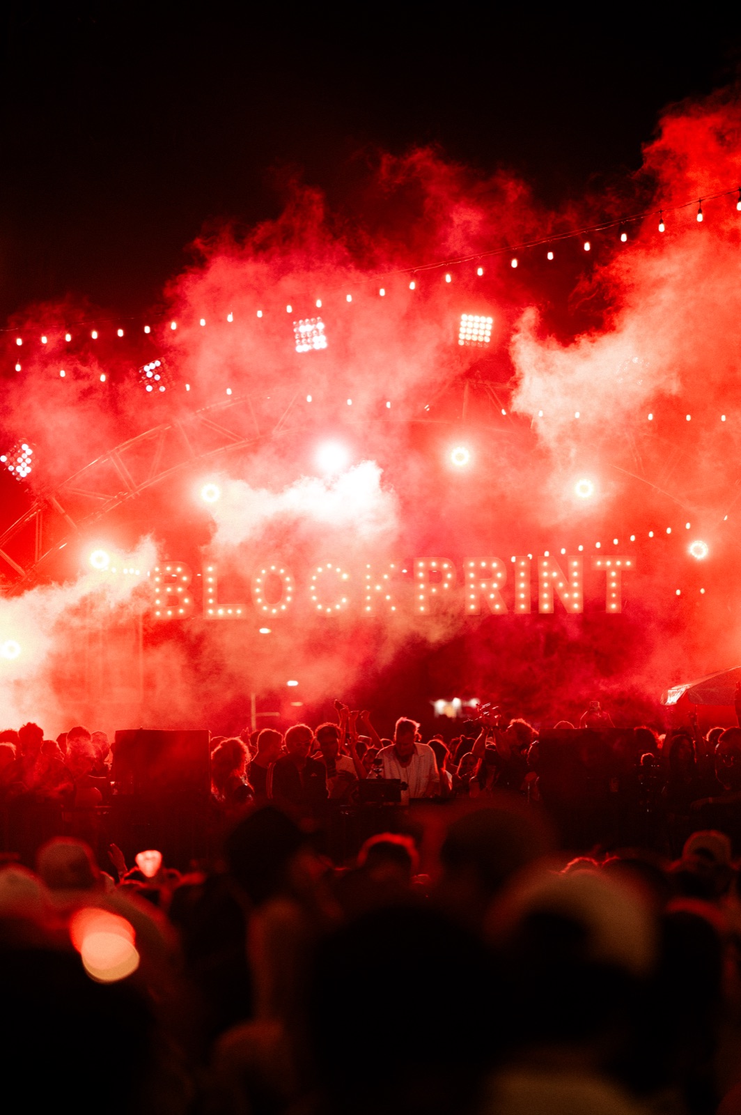 Red smoke over the night crowd
